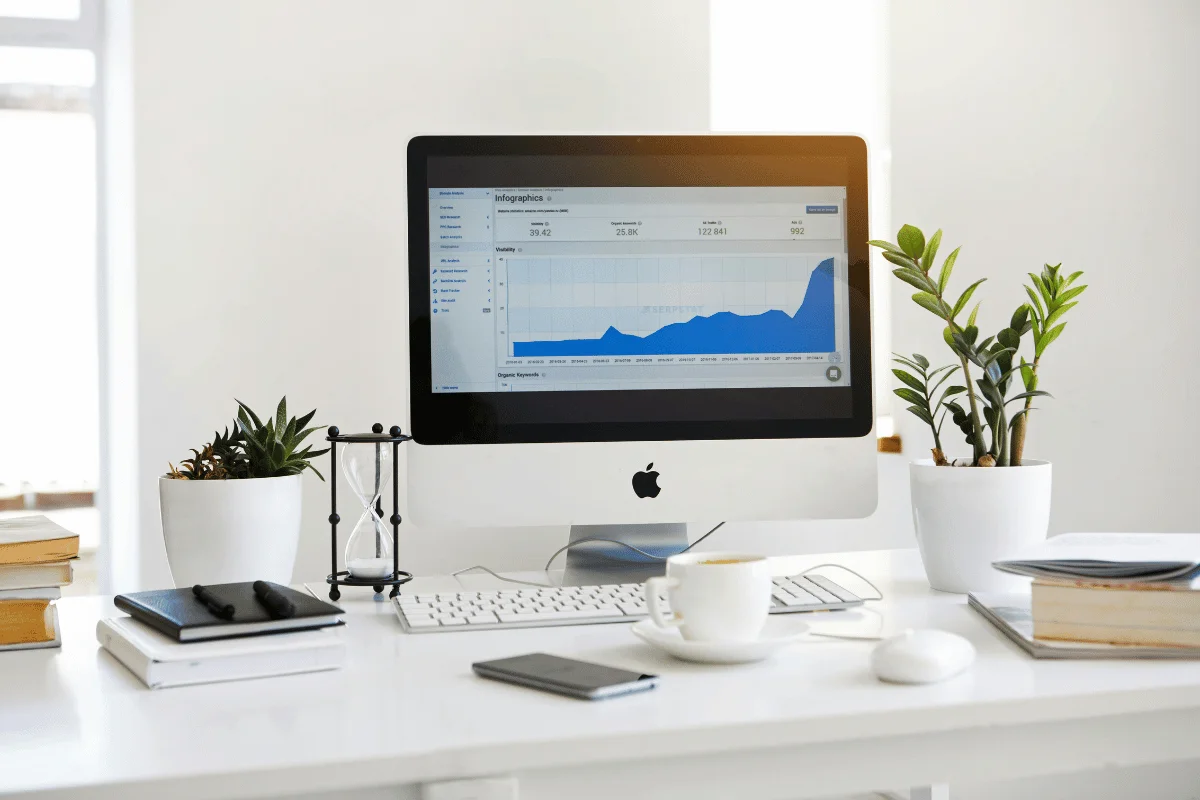 Desktop computer displaying website analytics on a clean modern office desk.